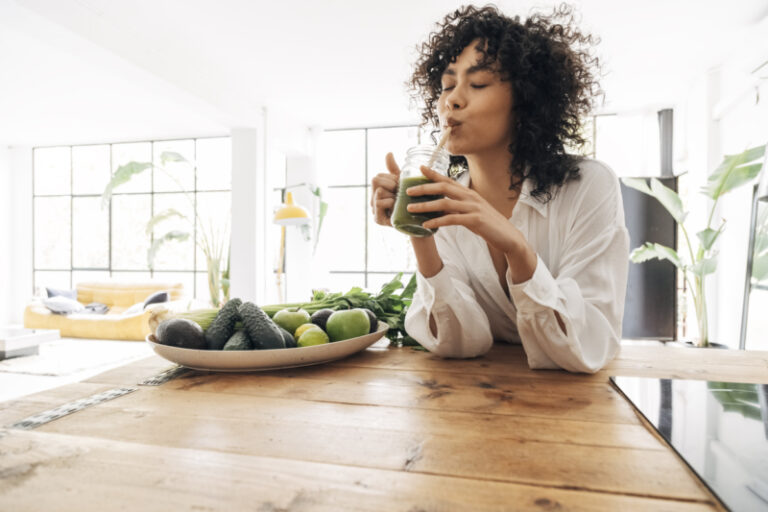 Women happily drinking smoothie after recovering from symptoms of mold toxicity