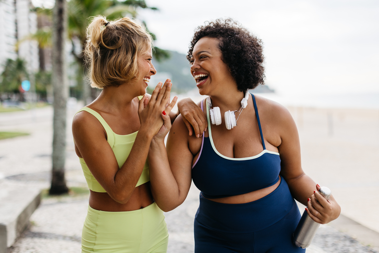 two happy women launching after a workout