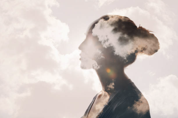 Image of a women with clouds to signify link between hormones and mental health